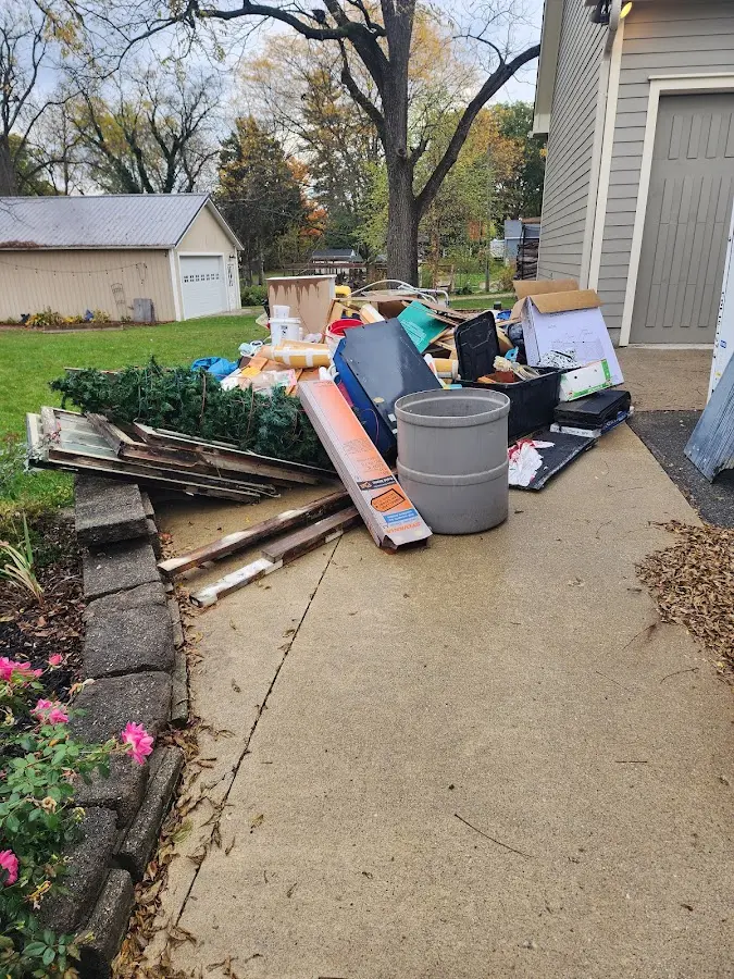 Dumpster being loaded with debris for 12 Yard Dumpster Rental in Brandermill
